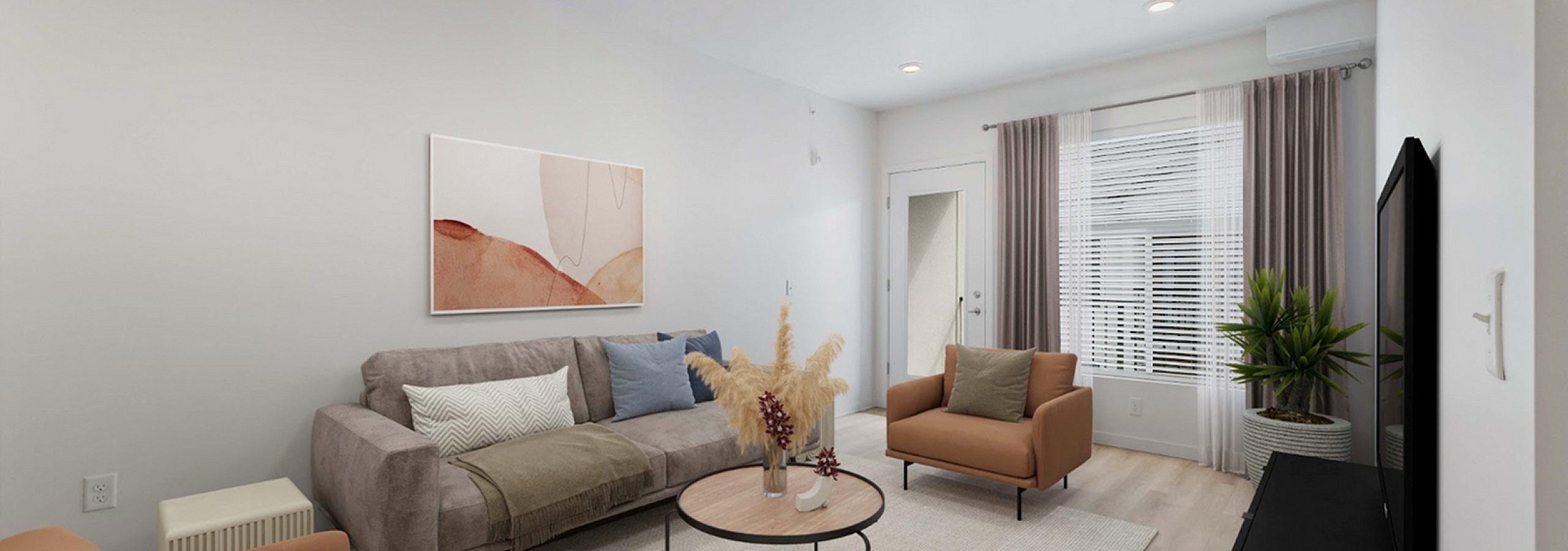 Living room with a sofa, armchair and large window at Victory Ranch