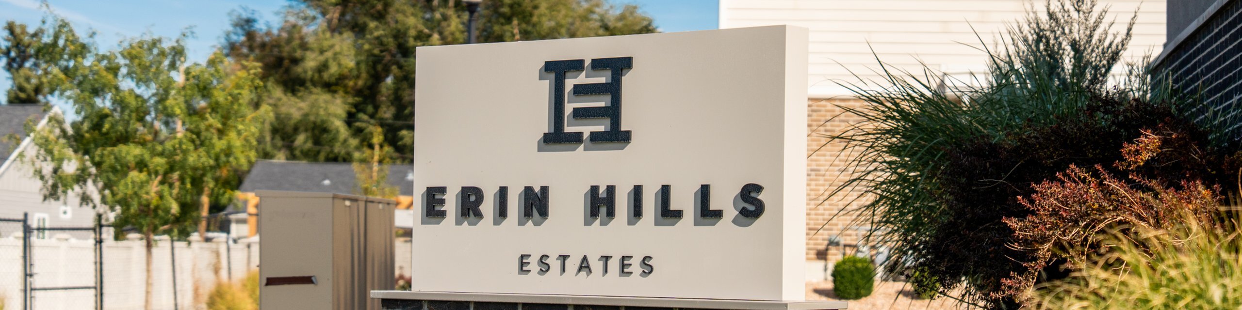 Erin Hills Estates monument sign at the community entrance in West Valley City, Utah, with landscaped grounds.