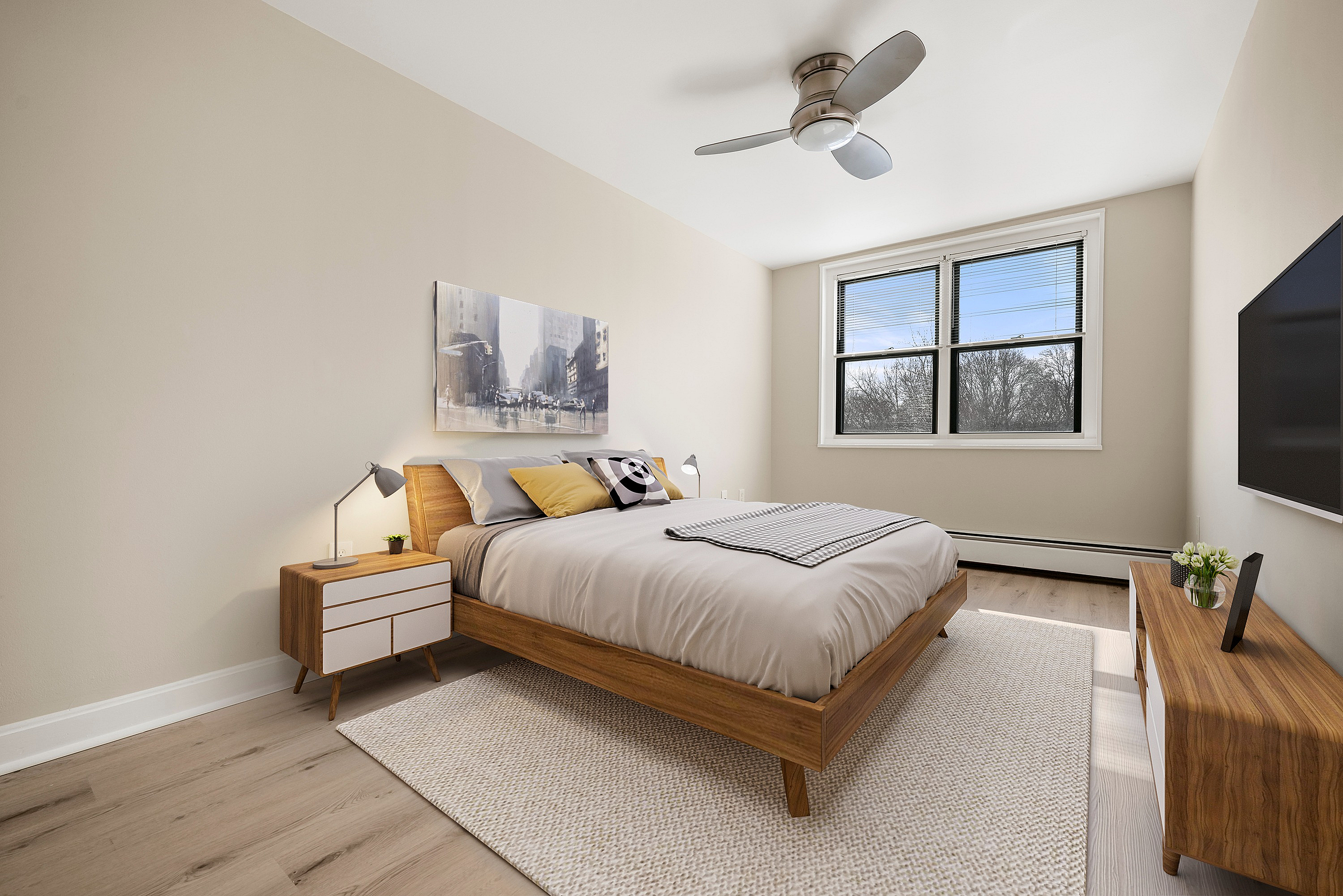 Elegant bedroom with a cozy queen-sized bed, modern decor, and large window offering a serene view.