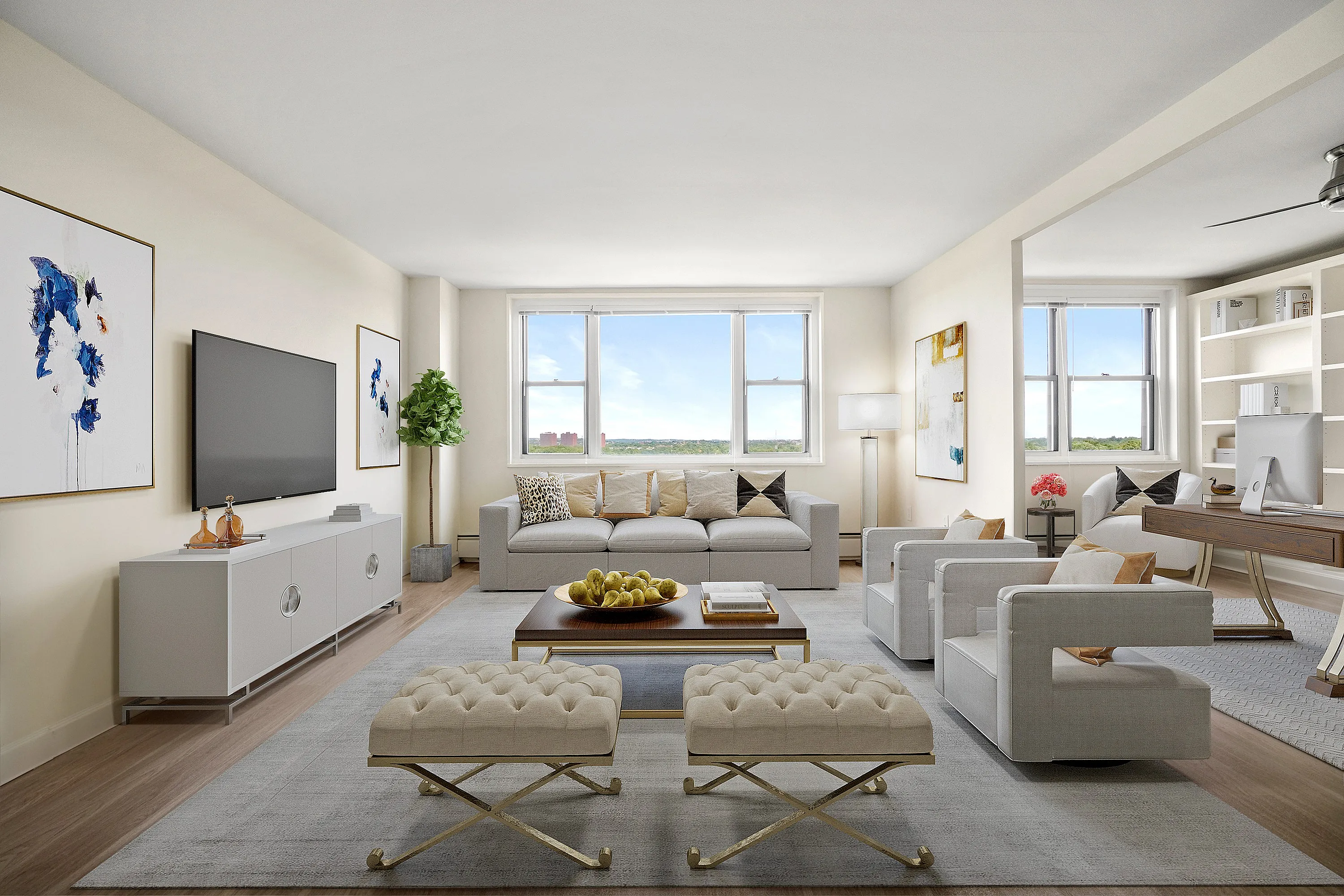 Bright and modern living room featuring plush seating, stylish decor, a large window with scenic views, and a cozy workspace.