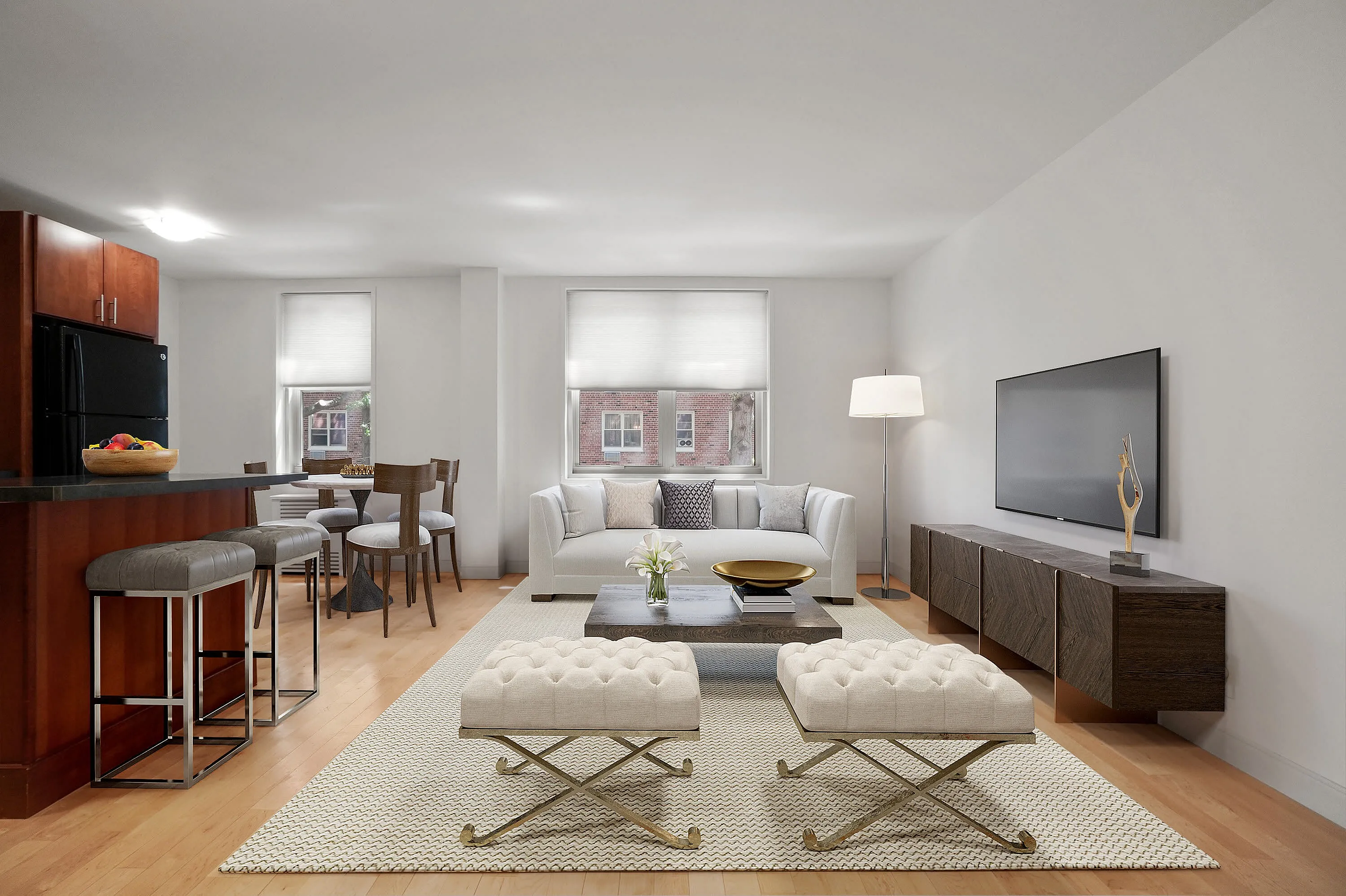 Modern open-concept living room with elegant furnishings, stylish kitchen and bar seating, featuring large windows for natural light.
