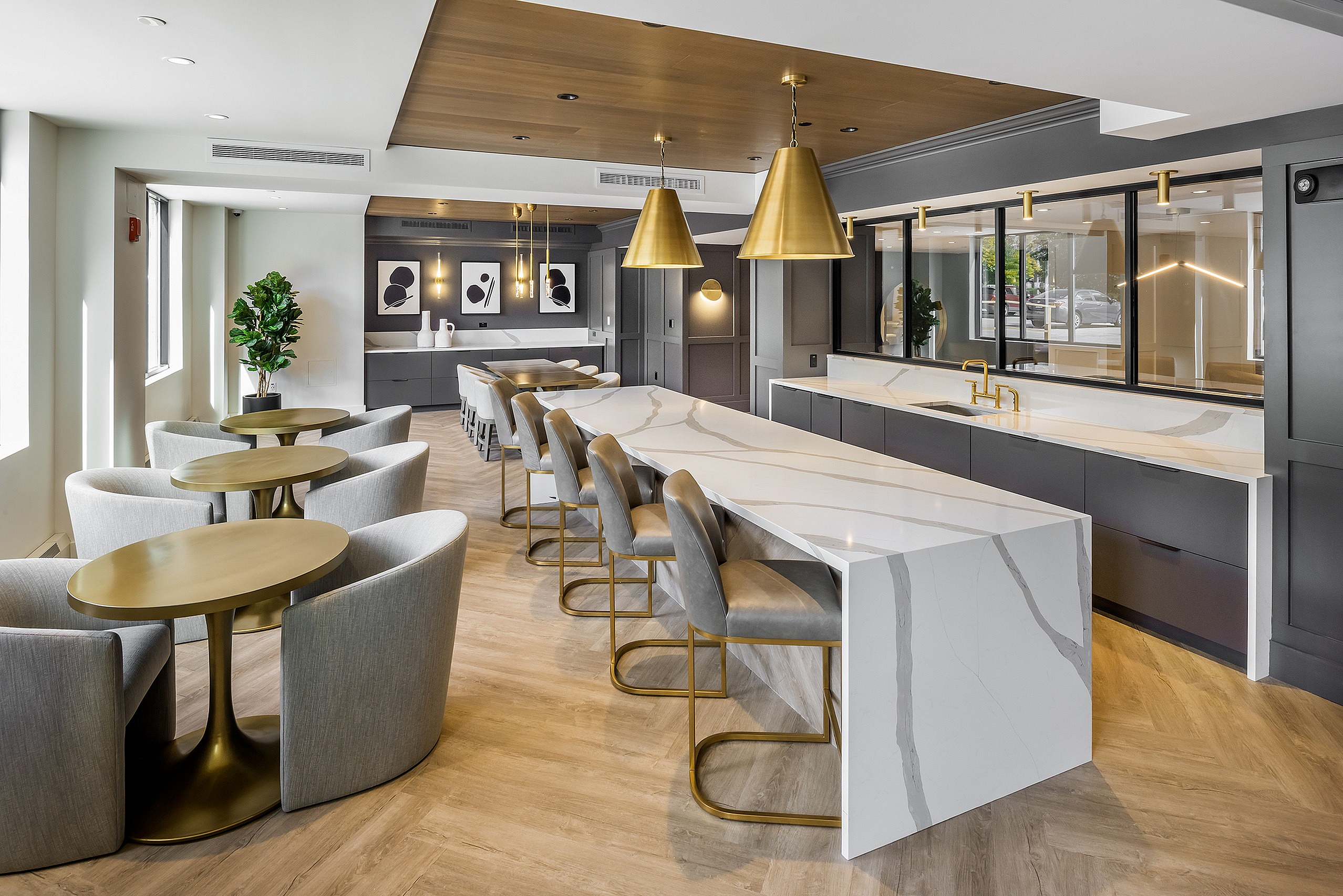 Luxurious modern communal space with stylish marble island, elegant seating, and contemporary lighting accents.