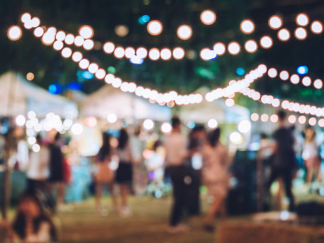 Charming outdoor market scene with twinkling string lights and vibrant atmosphere.