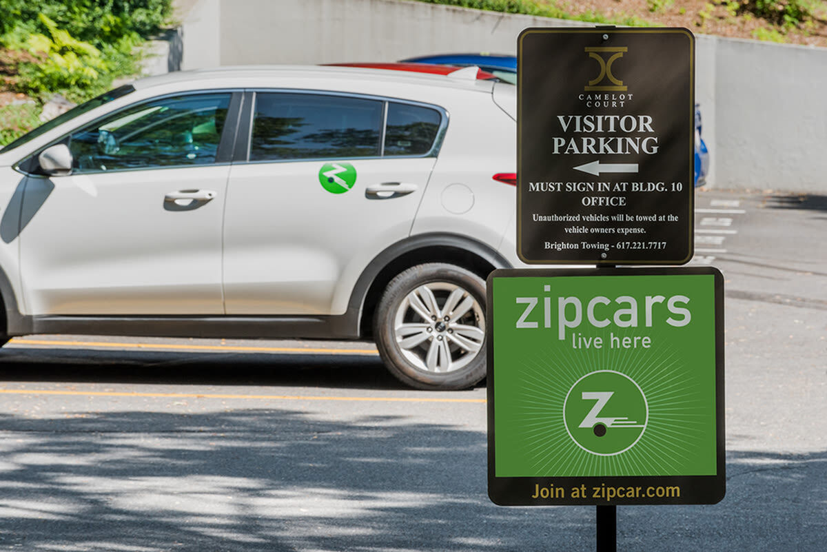 Convenient visitor parking area with prominent Zipcar availability, ideal for easy access and sustainable travel options.