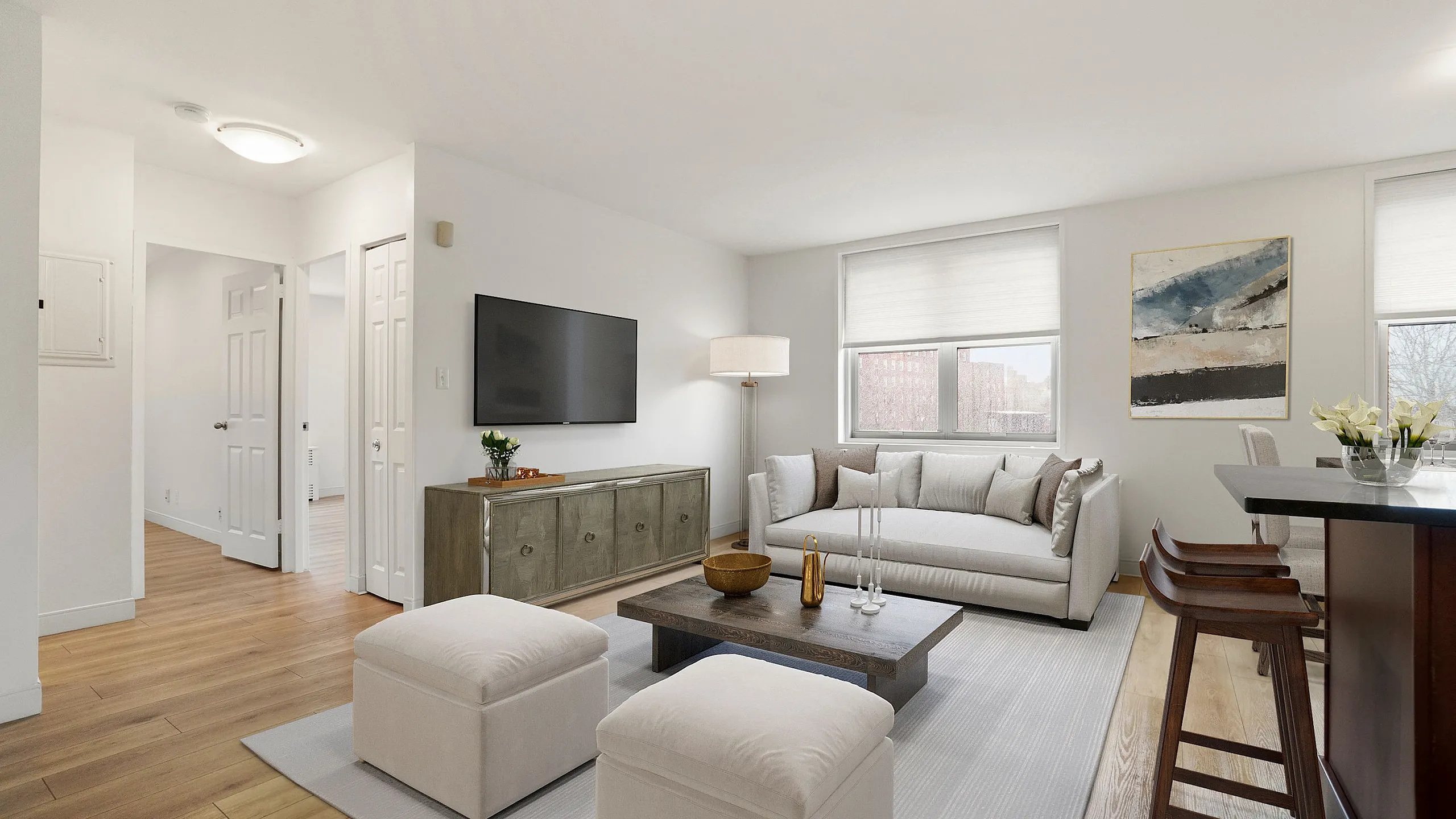 Elegant, modern living room with chic furnishings, hardwood floors, and ample natural light.