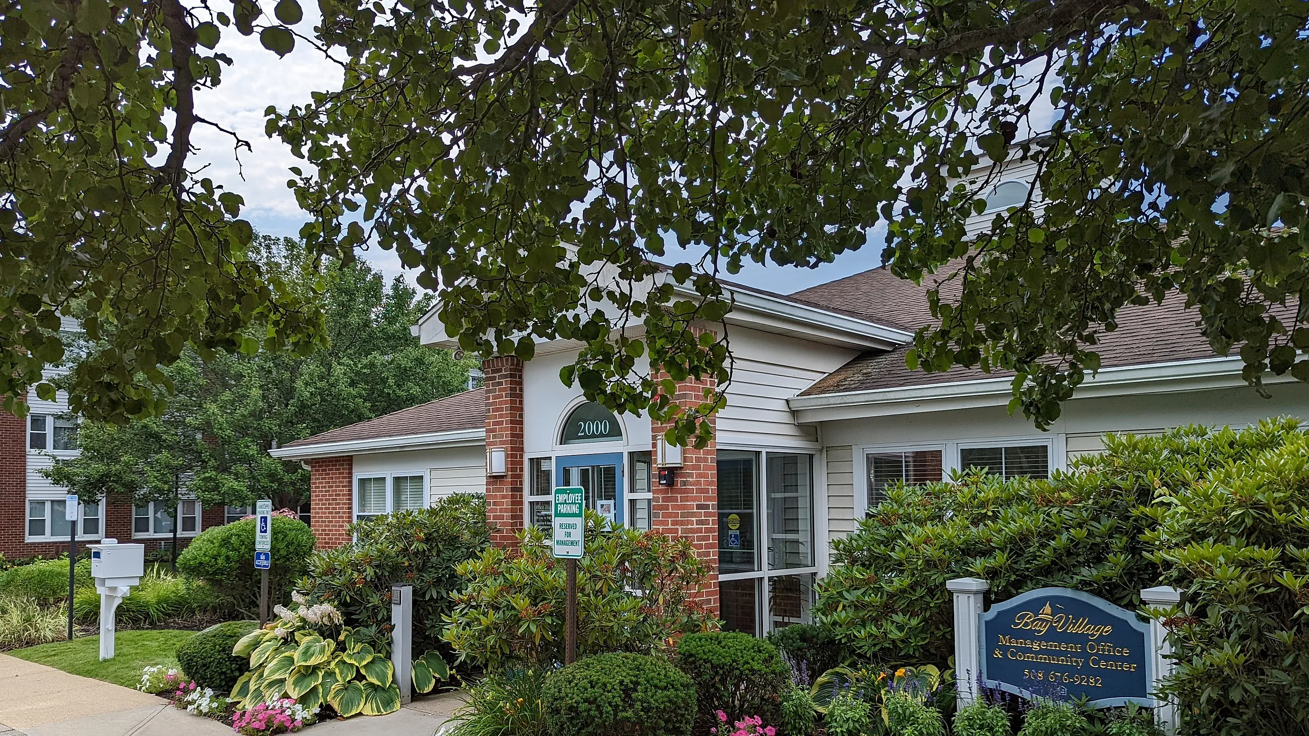 Charming community center with lush greenery and inviting entrance, ideal for residents seeking a vibrant neighborhood atmosphere.