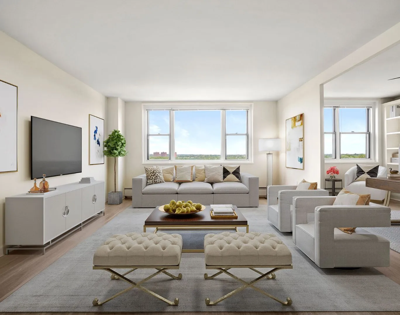 Bright and elegant living room with large windows, modern furnishings, and tasteful decor offering a serene view.