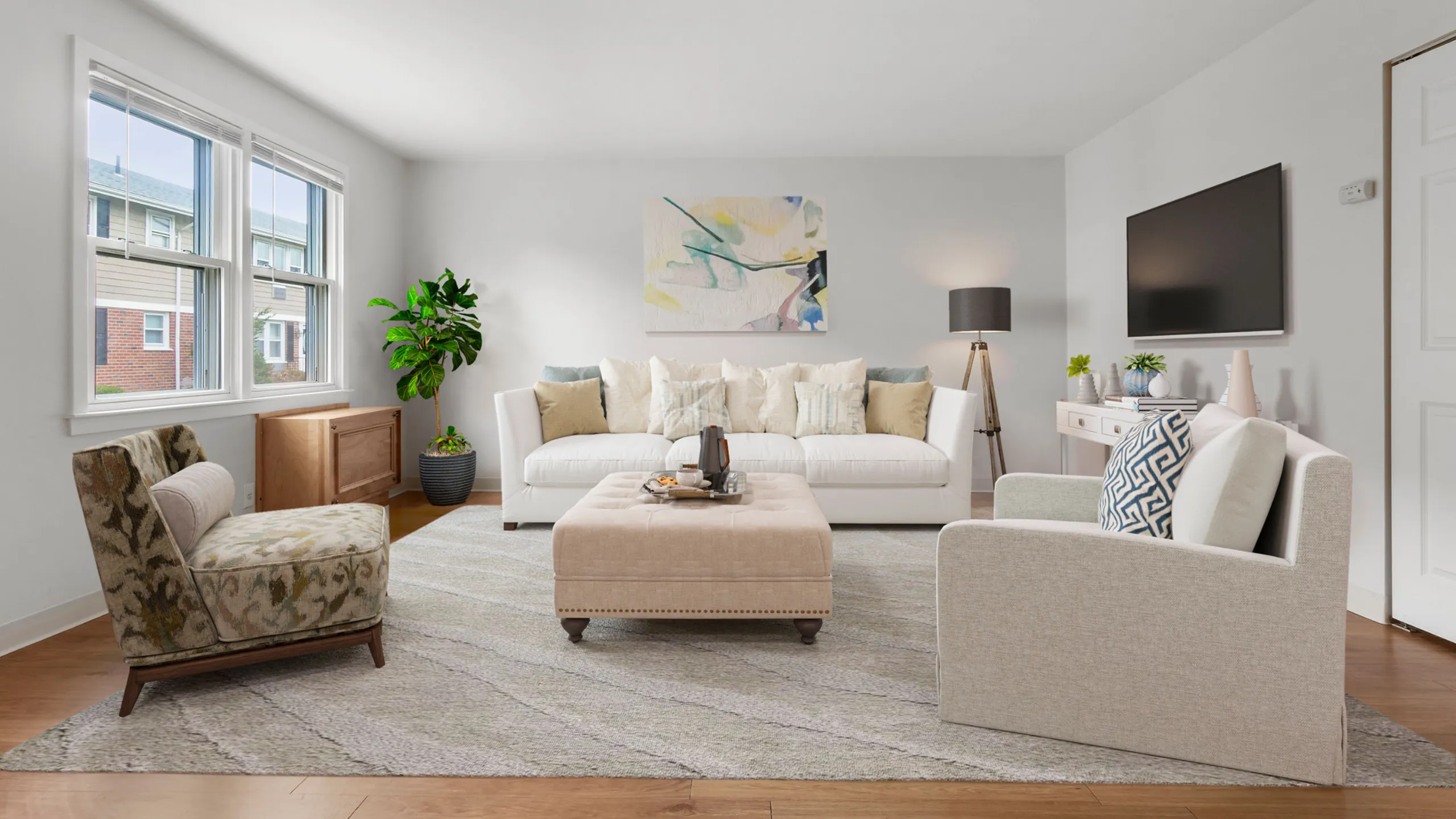 Bright and elegant living room featuring a cozy white sofa, stylish armchairs, and chic decor elements in a modern apartment setting.
