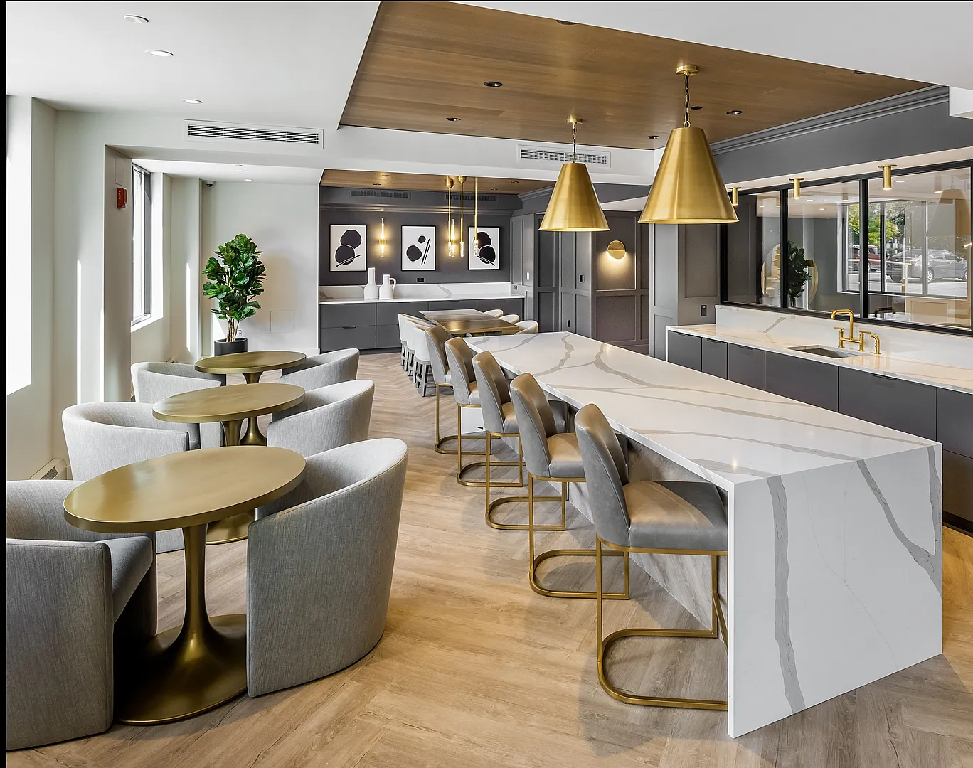 Modern and elegant communal dining area with stylish marble countertops, gold accents, and plush seating, offering a luxurious ambiance.