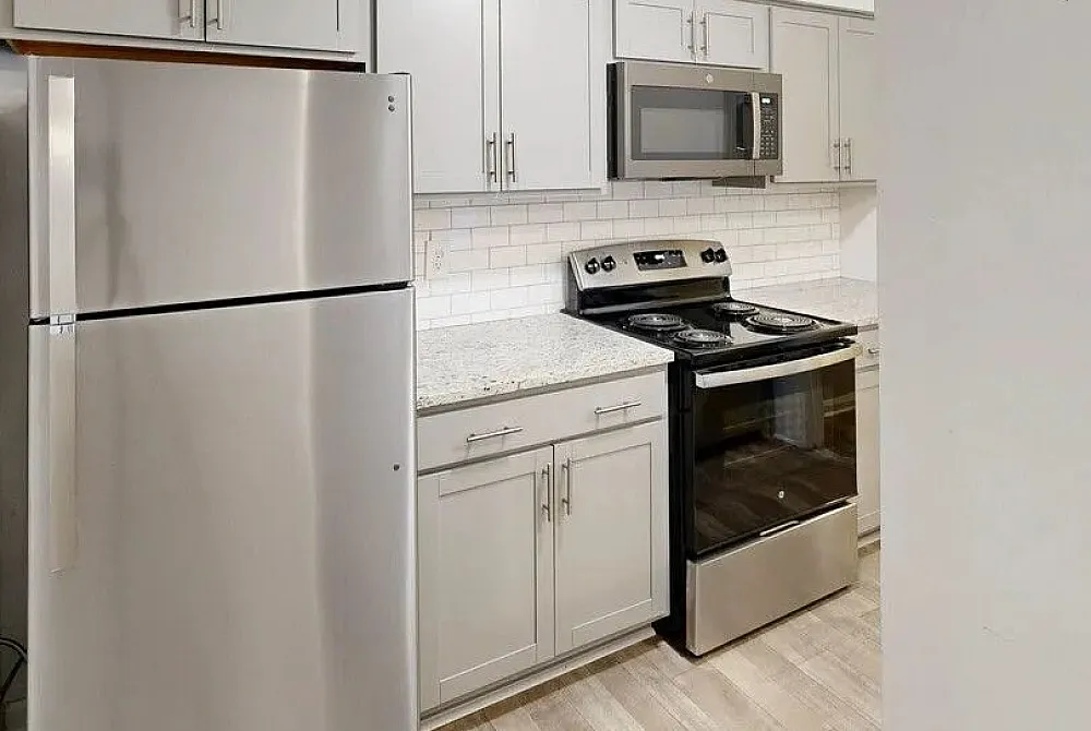 Modern kitchen with sleek stainless steel appliances, elegant countertops, and stylish cabinetry offering a chic culinary space.