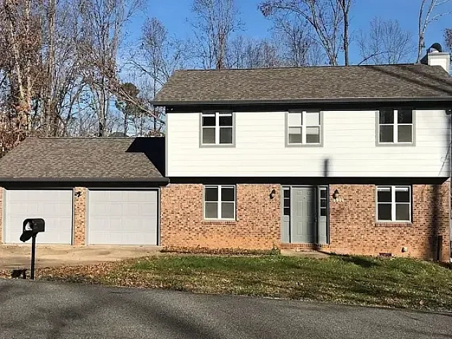 Split level house with mixed brick and siding.