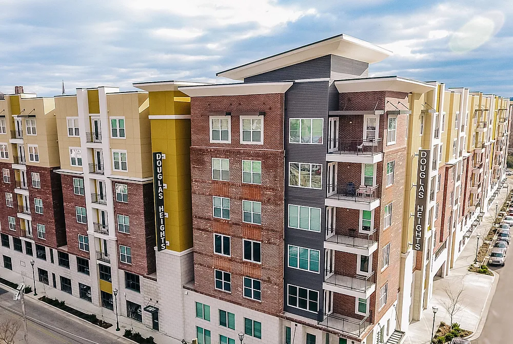 Modern apartment building with stylish balconies, vibrant exterior, and convenient urban location.