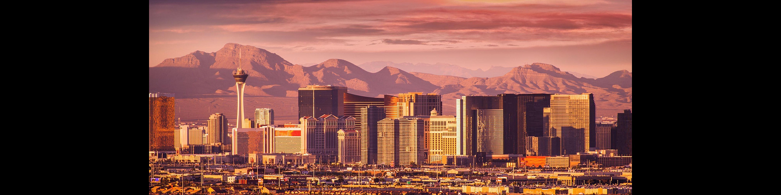 Breathtaking city skyline at sunset with majestic mountains in the background, highlighting the vibrant allure of urban living.
