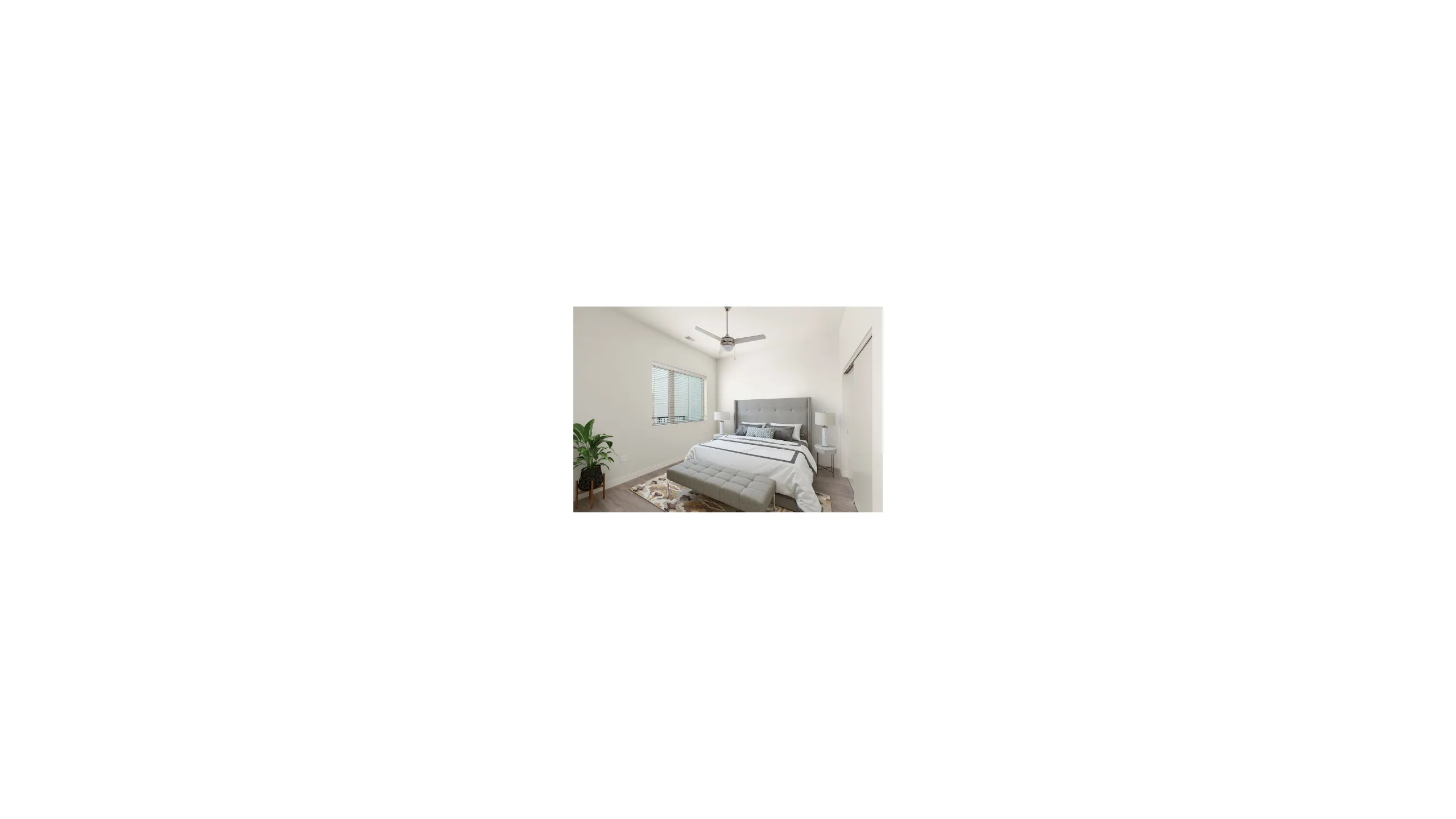 Inviting bedroom with modern decor, featuring a cozy bed, elegant lighting, and large window for natural light.