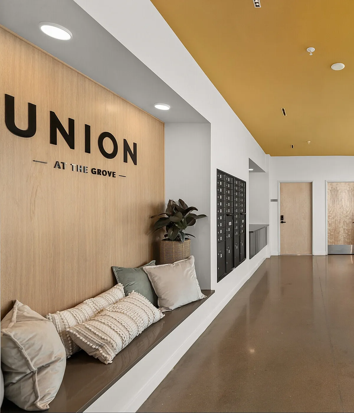 Inviting lobby of Union at The Grove showcasing contemporary design with cozy seating and sleek wooden finishes.