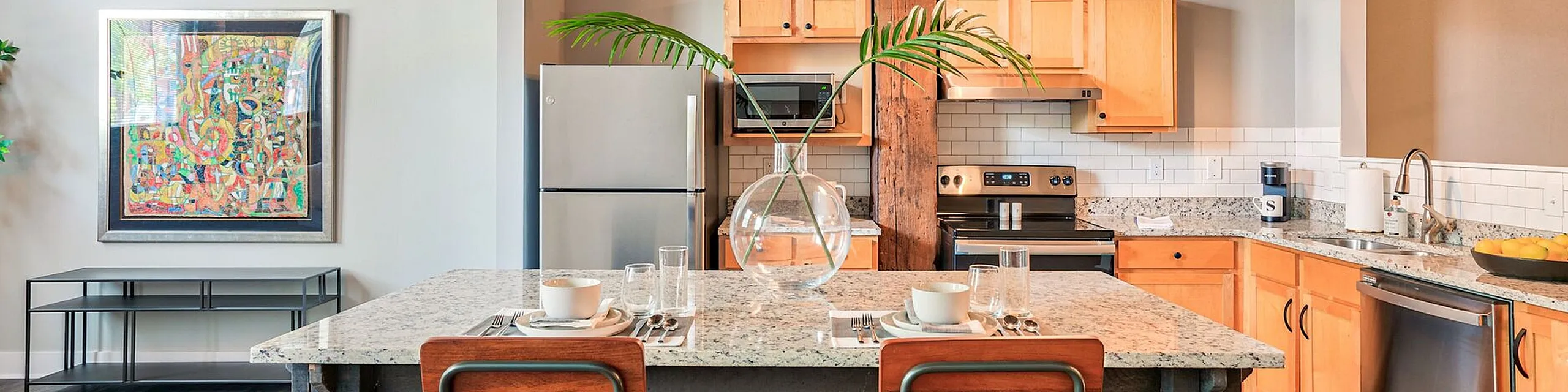 Charming industrial-style kitchen with wooden beams, modern appliances, and a cozy breakfast bar for two.