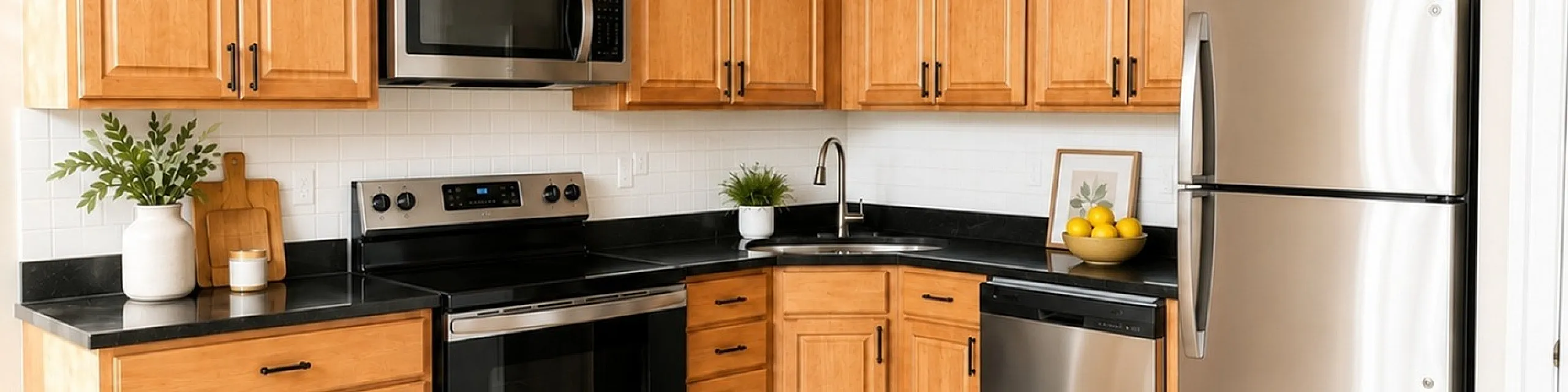 Bright kitchen with elegant wooden cabinets, sleek stainless steel appliances, and a charming lemon-themed rug.