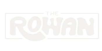 Bold and stylish logo for 'The Rowan' featuring modern typography with a playful design.