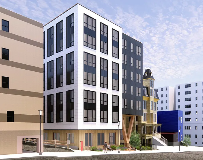 Contemporary apartment complex with sleek facade and large windows, nestled in an urban setting under a bright, clear sky.