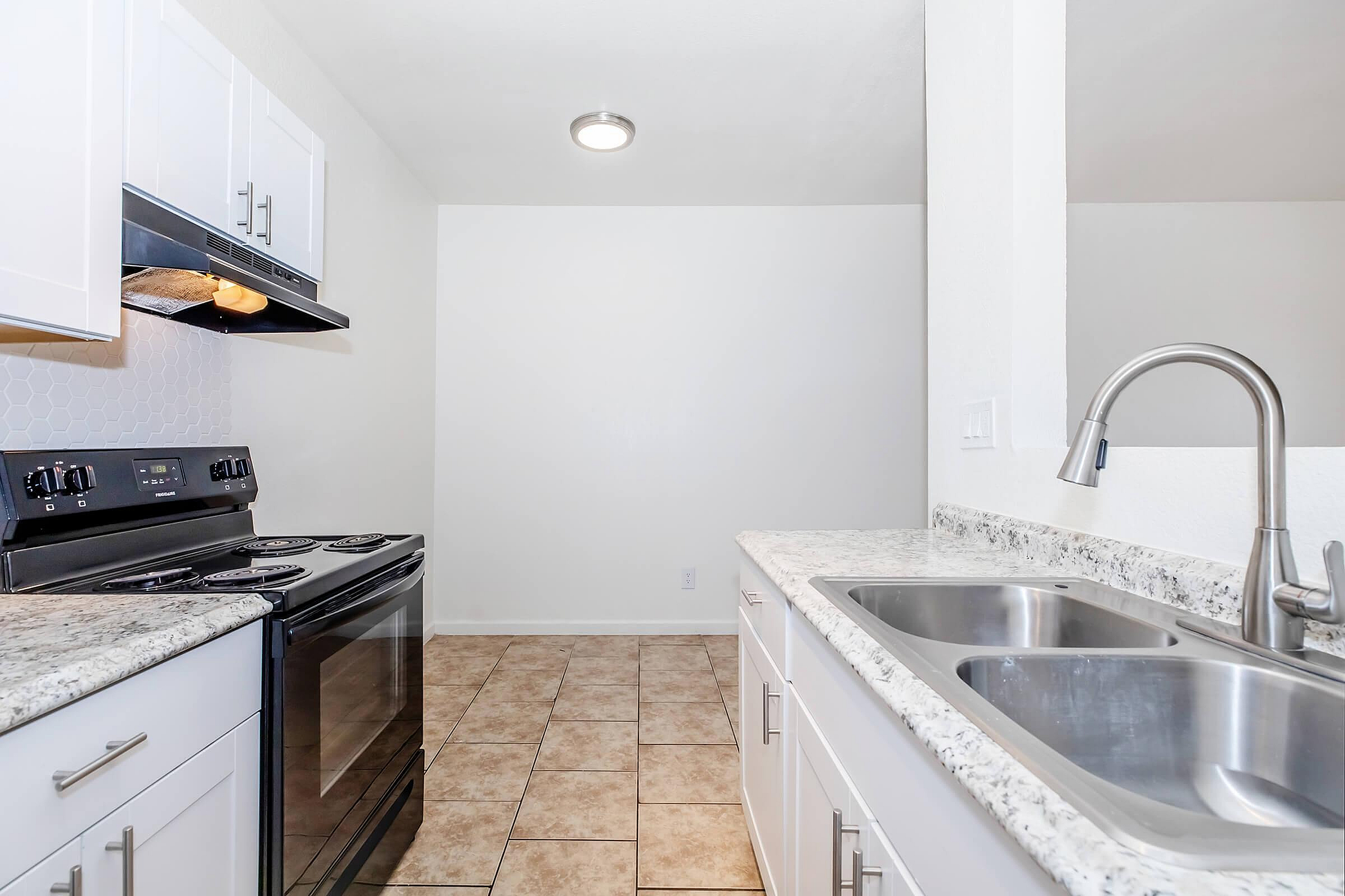 Modern kitchen with sleek appliances, elegant granite countertops, and stylish cabinetry.