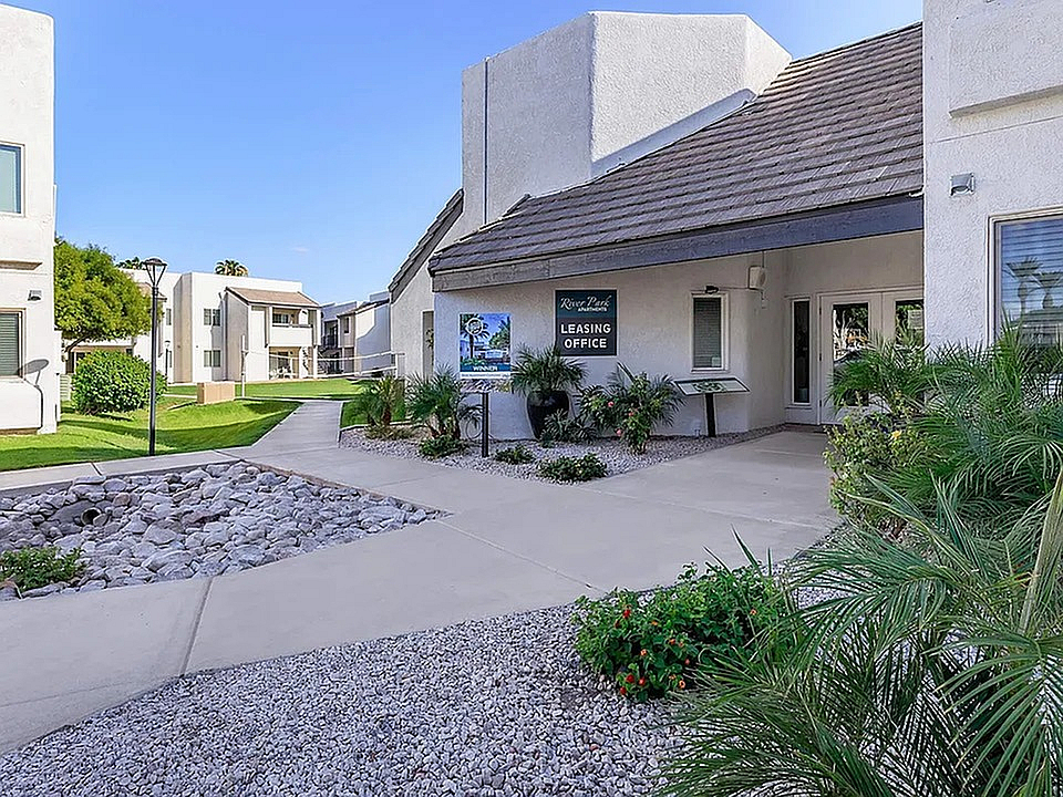River Park leasing-office entrance beside a walkway and landscaped grounds.