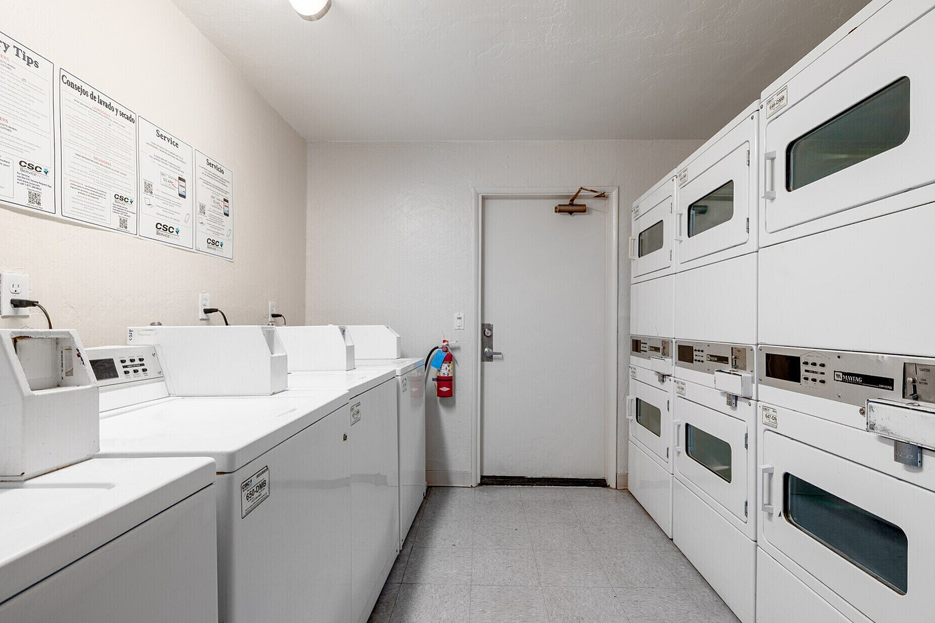 Bright and efficient laundry room featuring modern washing machines and dryers for added convenience.