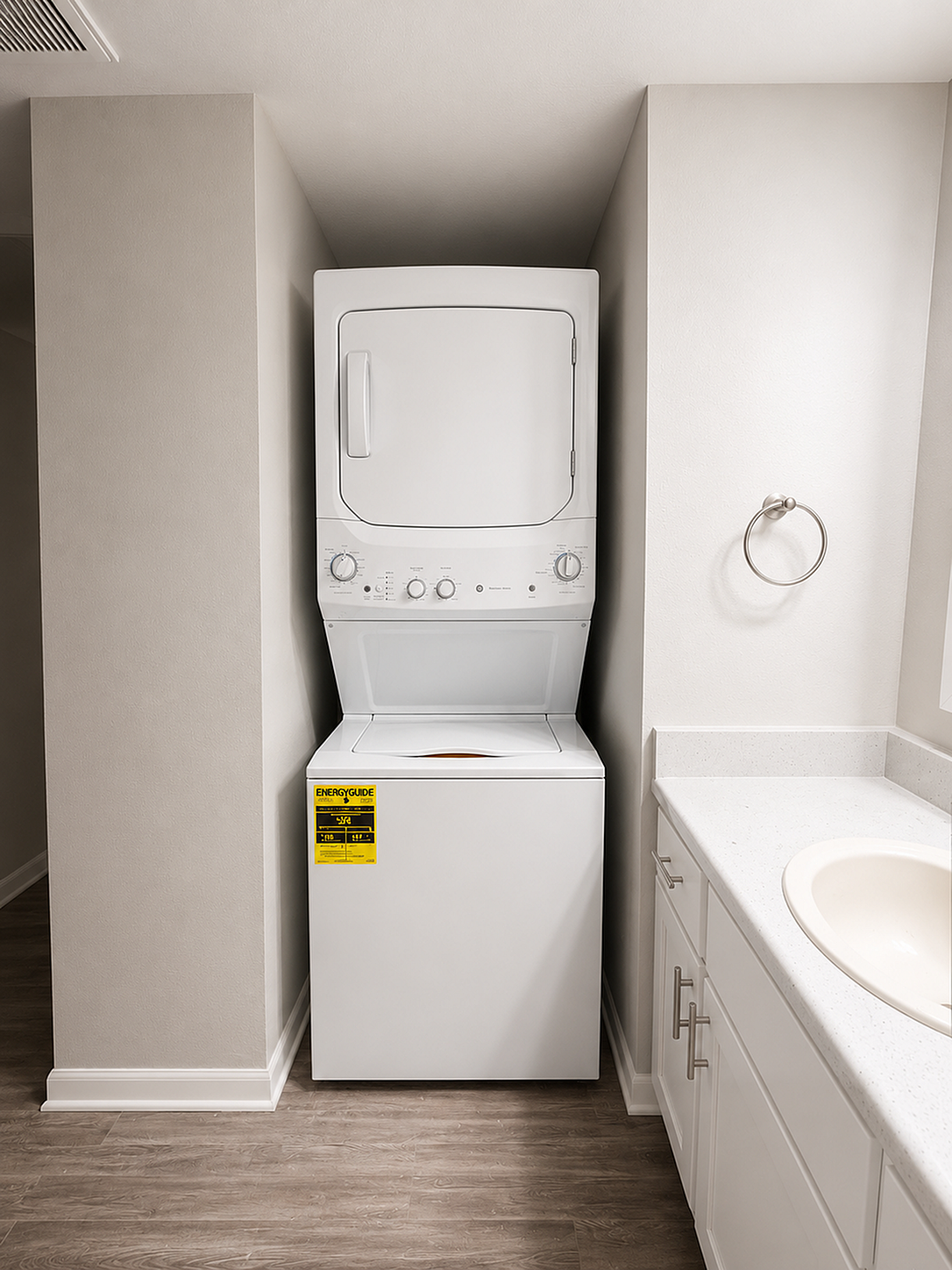 Modern apartment with sleek in-unit laundry, stylish stone countertops, and elegant cabinetry.