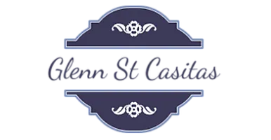 Elegant logo design with a navy blue emblem and delicate floral accents.