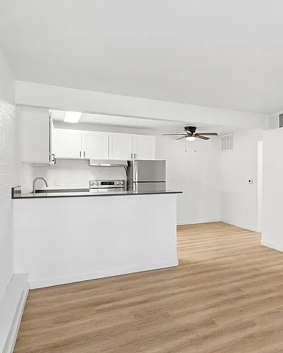 Renovated kitchen with stainless steel appliances and white cabinetry at Miramonte on 3rd, Tucson