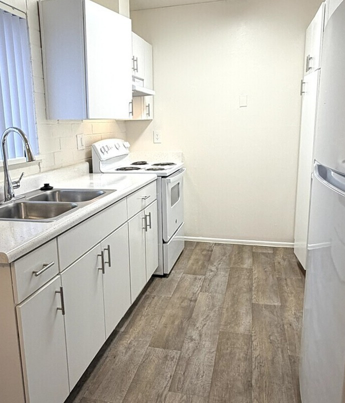 Charming kitchen with modern white cabinetry, sleek countertops, and spacious layout perfect for home cooking.