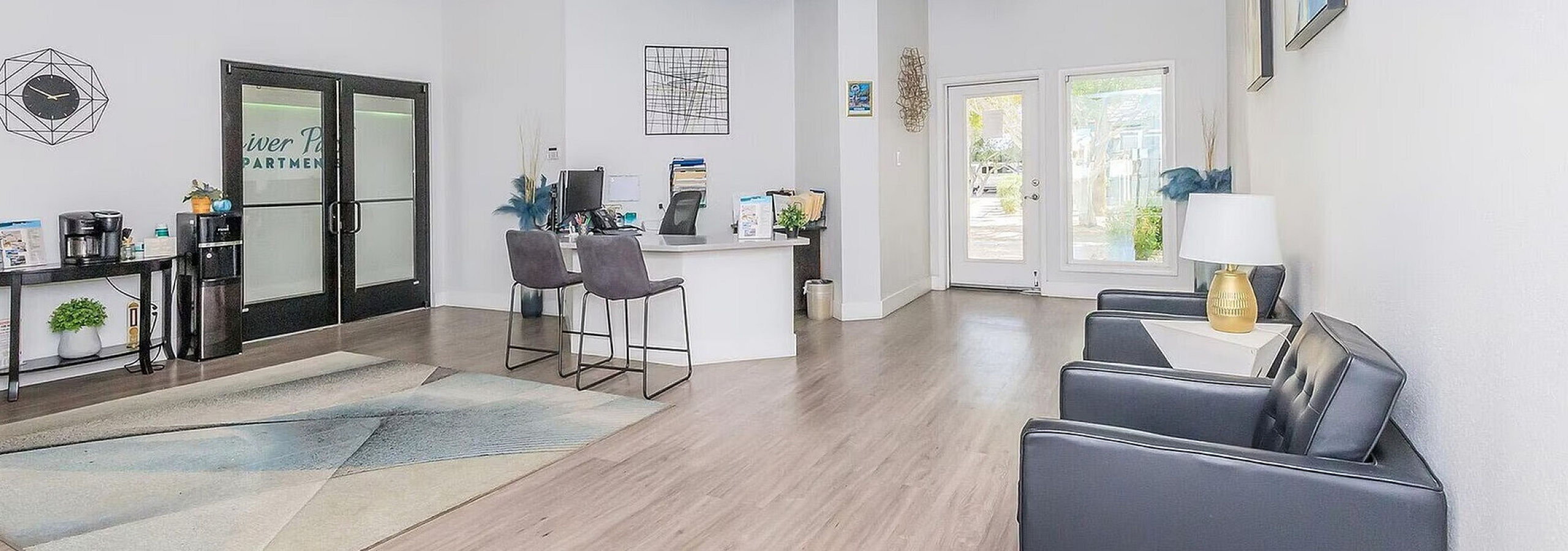 Modern apartment lobby with sleek design, open layout, and stylish decor featuring comfortable seating and a welcoming reception desk.