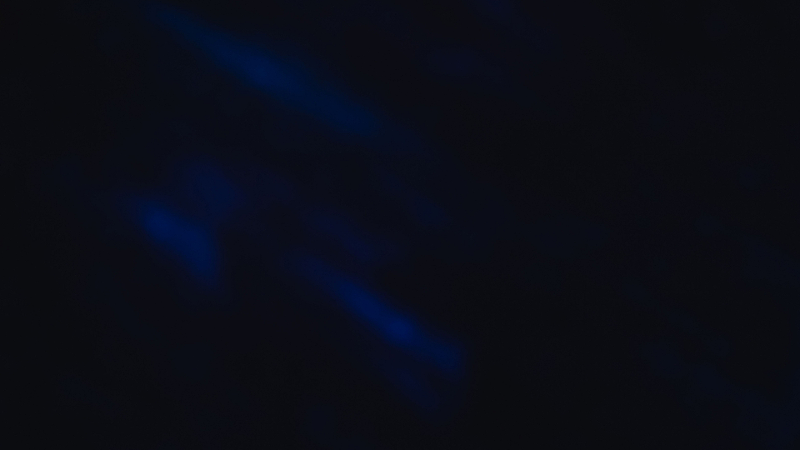 Dark abstract image with subtle blue hues creating a mysterious and tranquil ambiance.