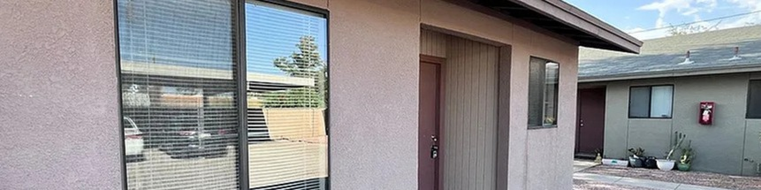 Charming apartment exterior with modern windows and a welcoming entrance, perfect for cozy living.