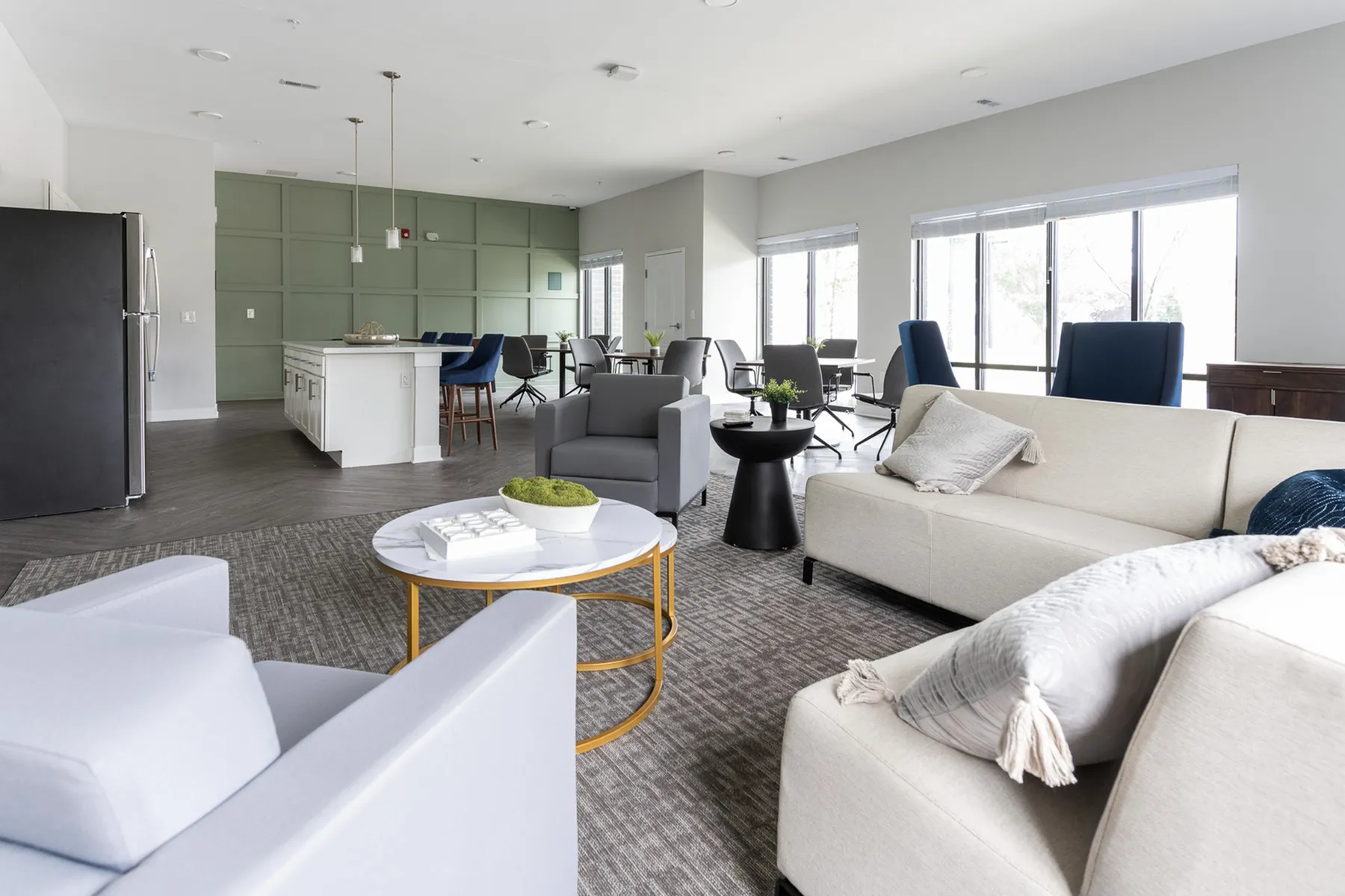 Bright and Spacious Community Lounge with Seating and Kitchen Area