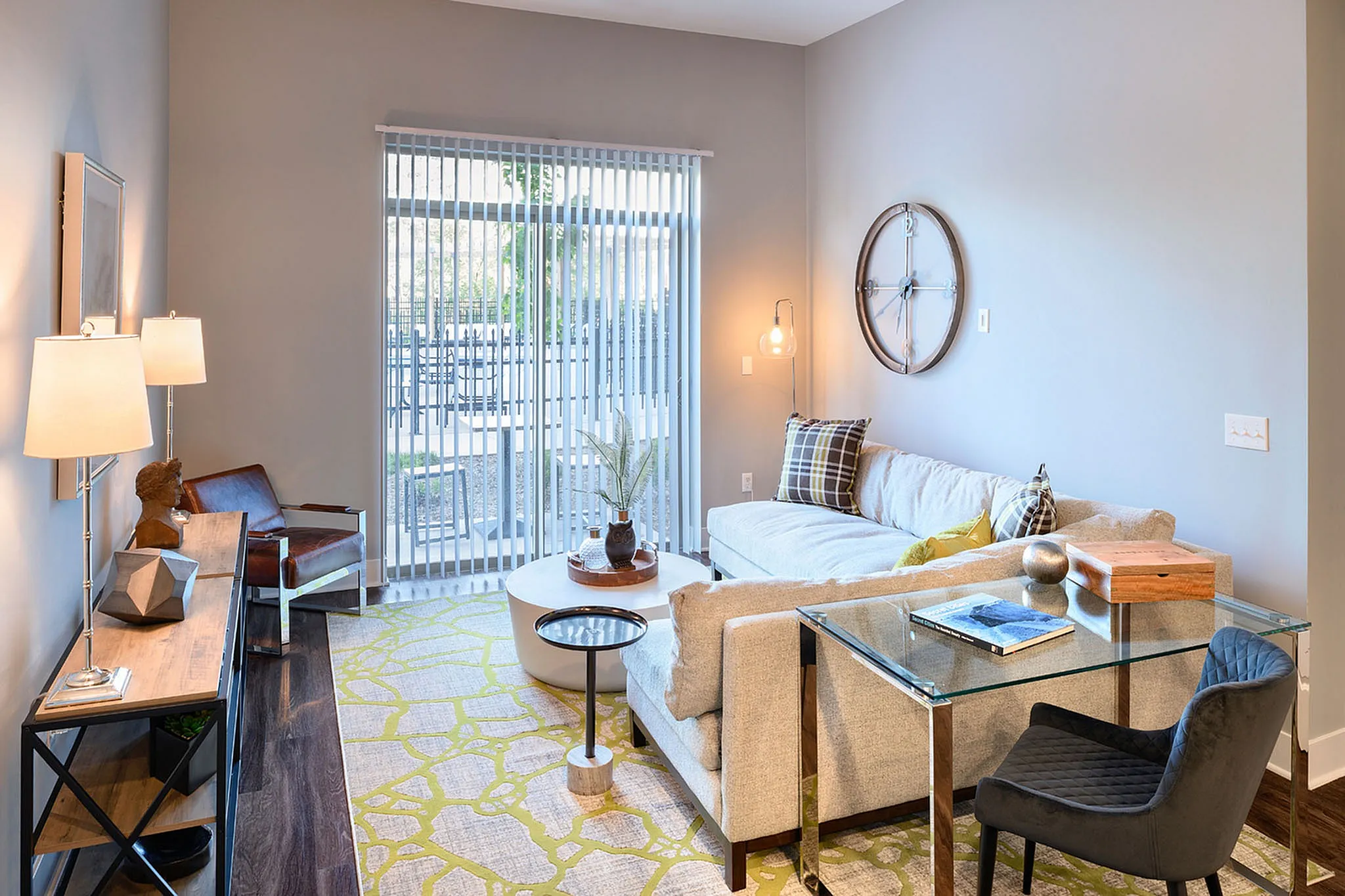 Chic modern living room with a cozy sectional, stylish decor, and ample natural light from large sliding doors.
