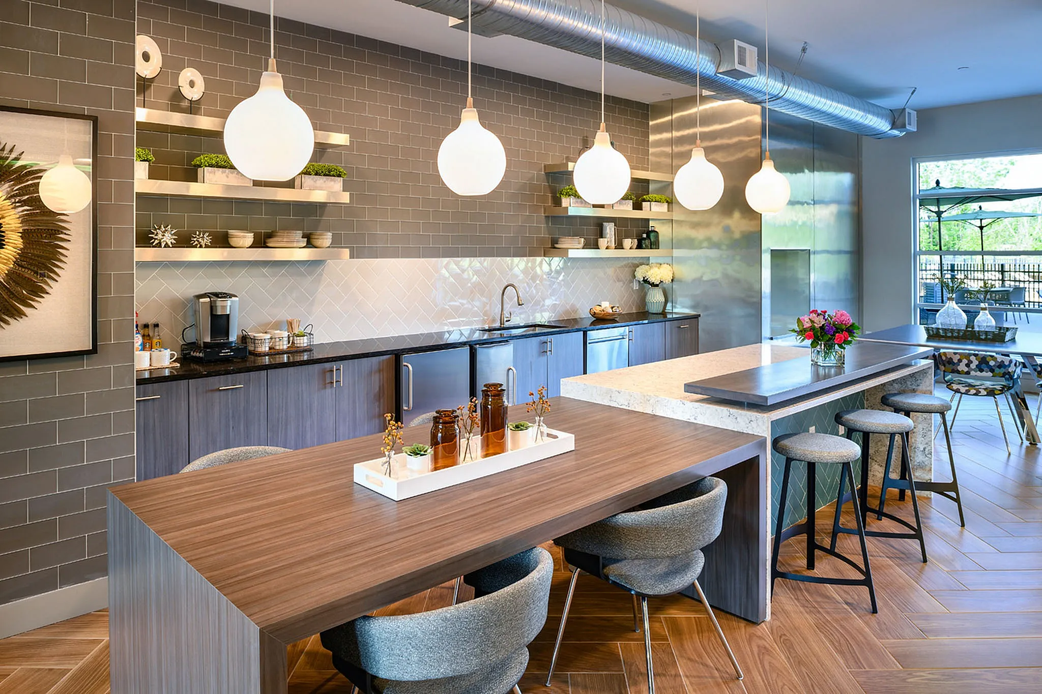 Modern kitchen with sleek cabinetry, chic pendant lighting, and a spacious island, perfect for entertaining.