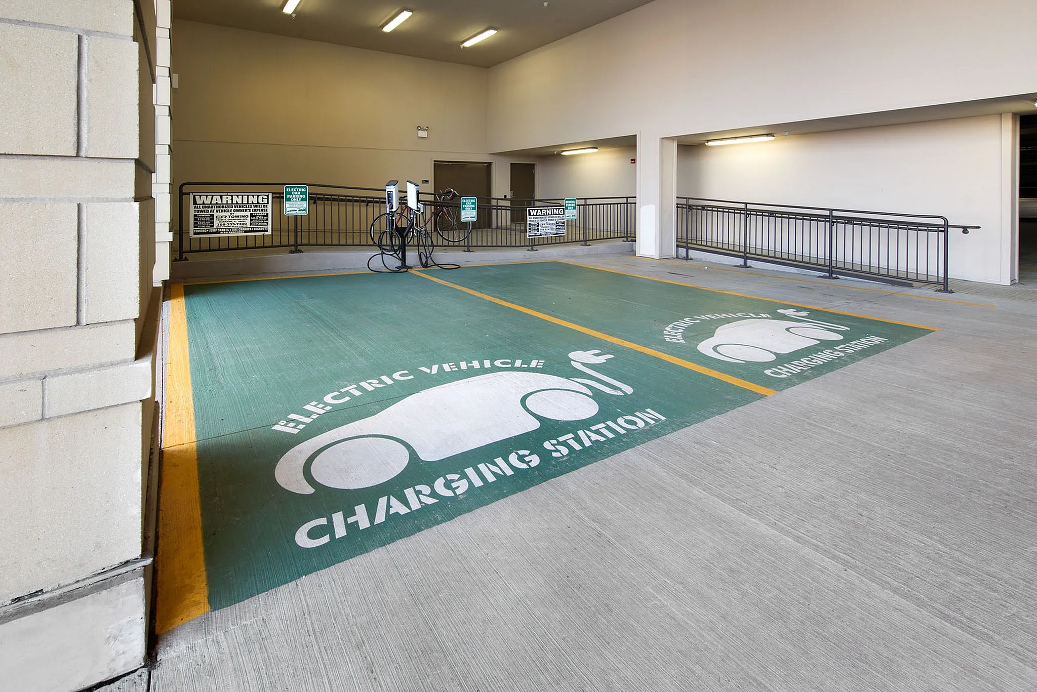 Modern apartment parking facility featuring eco-friendly electric vehicle charging stations, offering convenience and sustainability.
