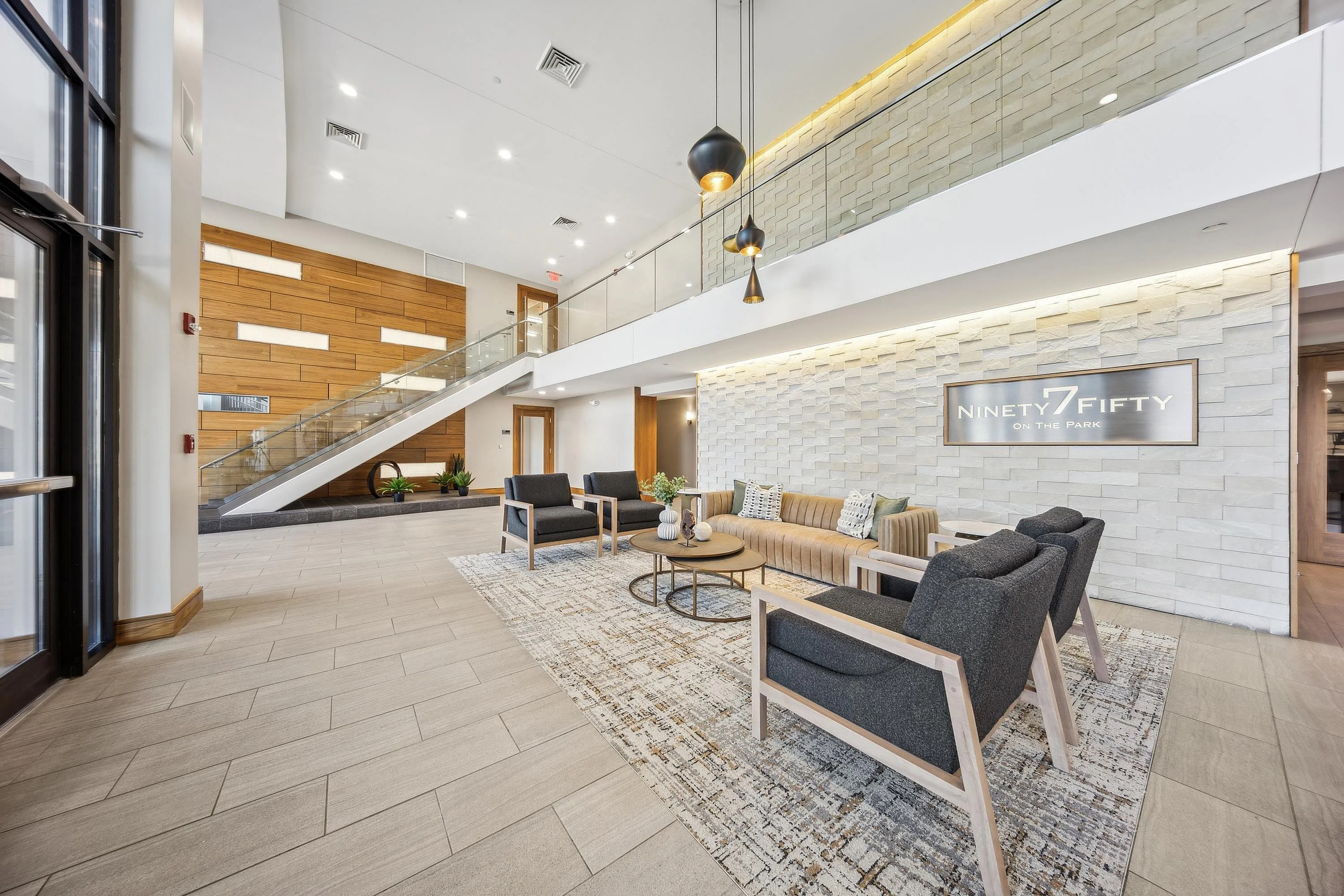 Modern and inviting lobby area of Ninety7Fifty on the Park, featuring stylish seating, elegant lighting, and a contemporary staircase.