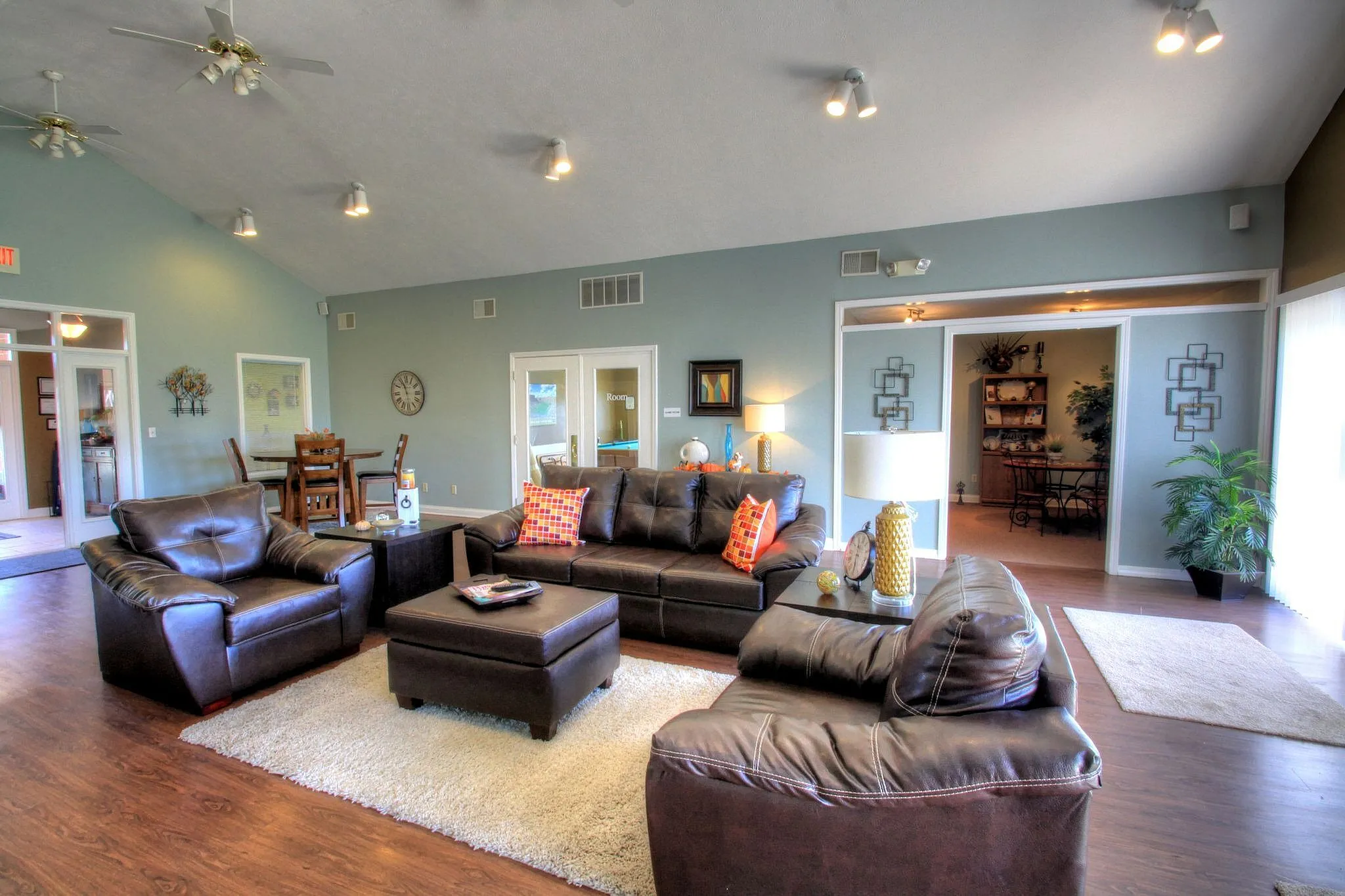 Inviting living room with plush leather sofas, stylish decor, and abundant natural light.
