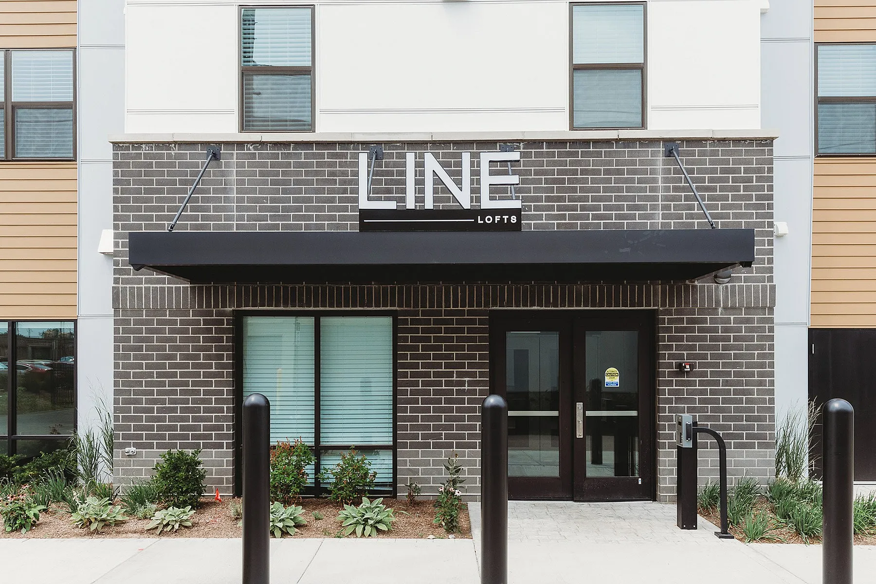 Modern entrance to Line Lofts featuring sleek brickwork and contemporary design elements.