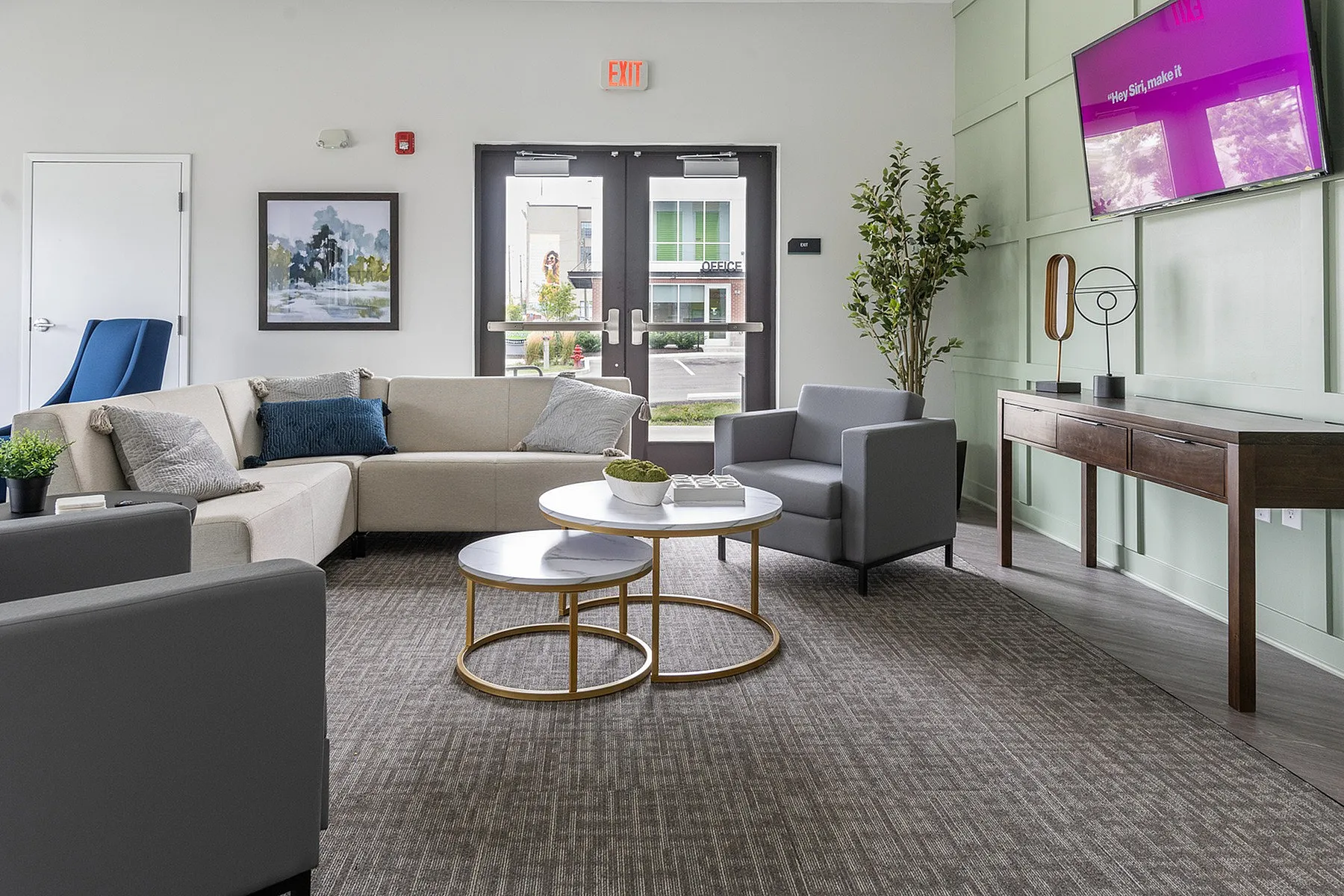 Chic living room with stylish furniture, a plush L-shaped sofa, modern coffee tables, and a wall-mounted TV.