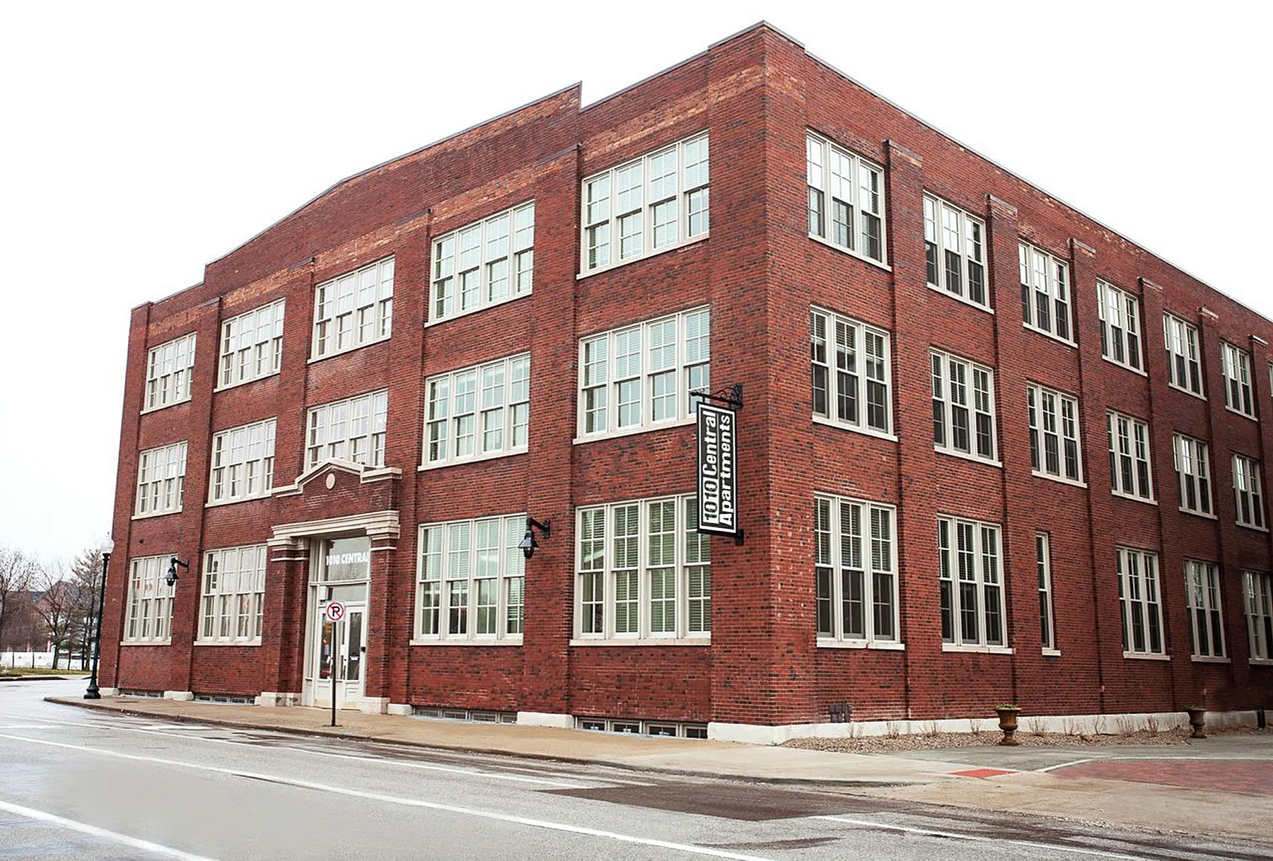 Charming red brick apartment building with large windows, offering modern urban living and historic architectural appeal.