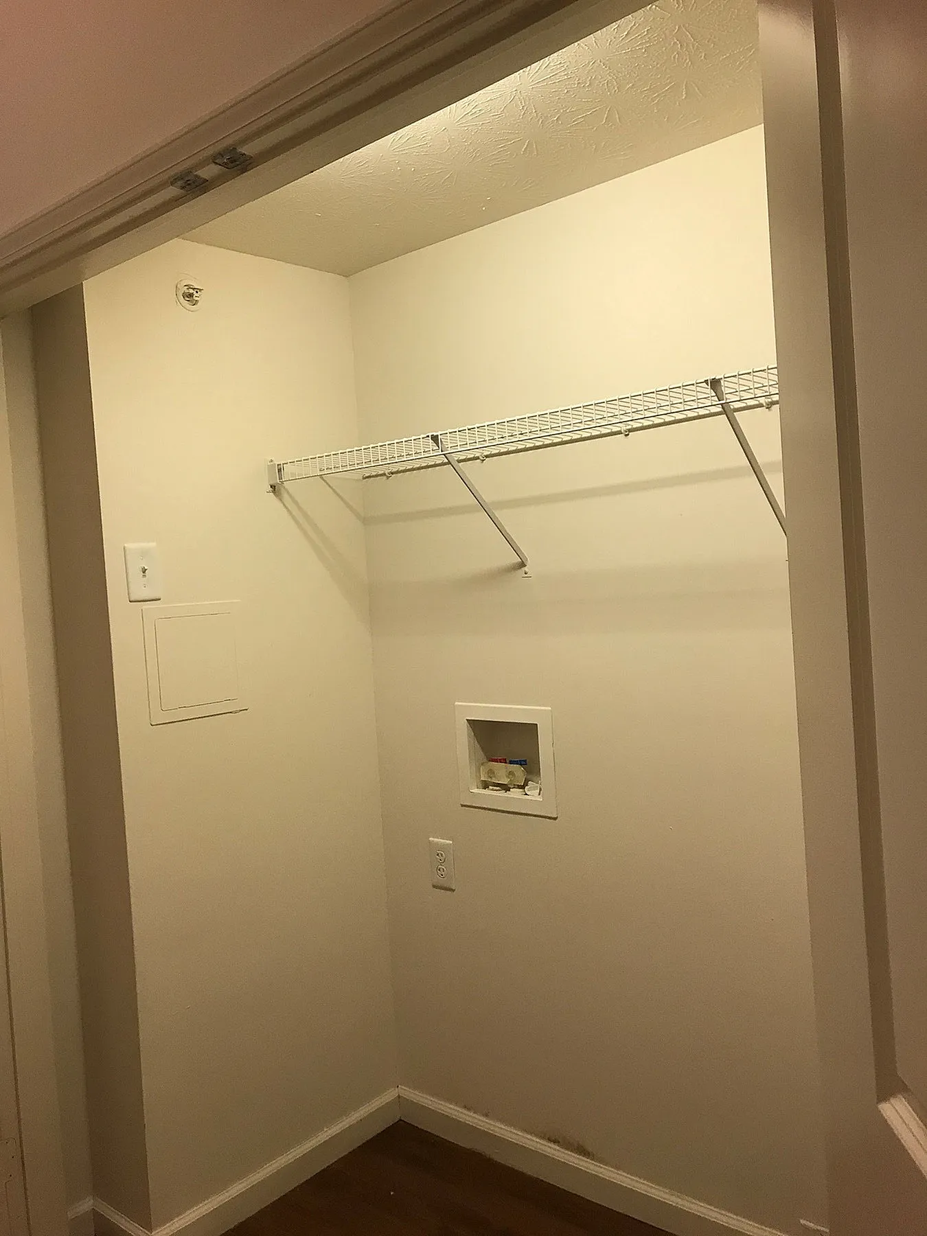Cozy walk-in closet with ample space and sleek lighting, perfect for organized living.