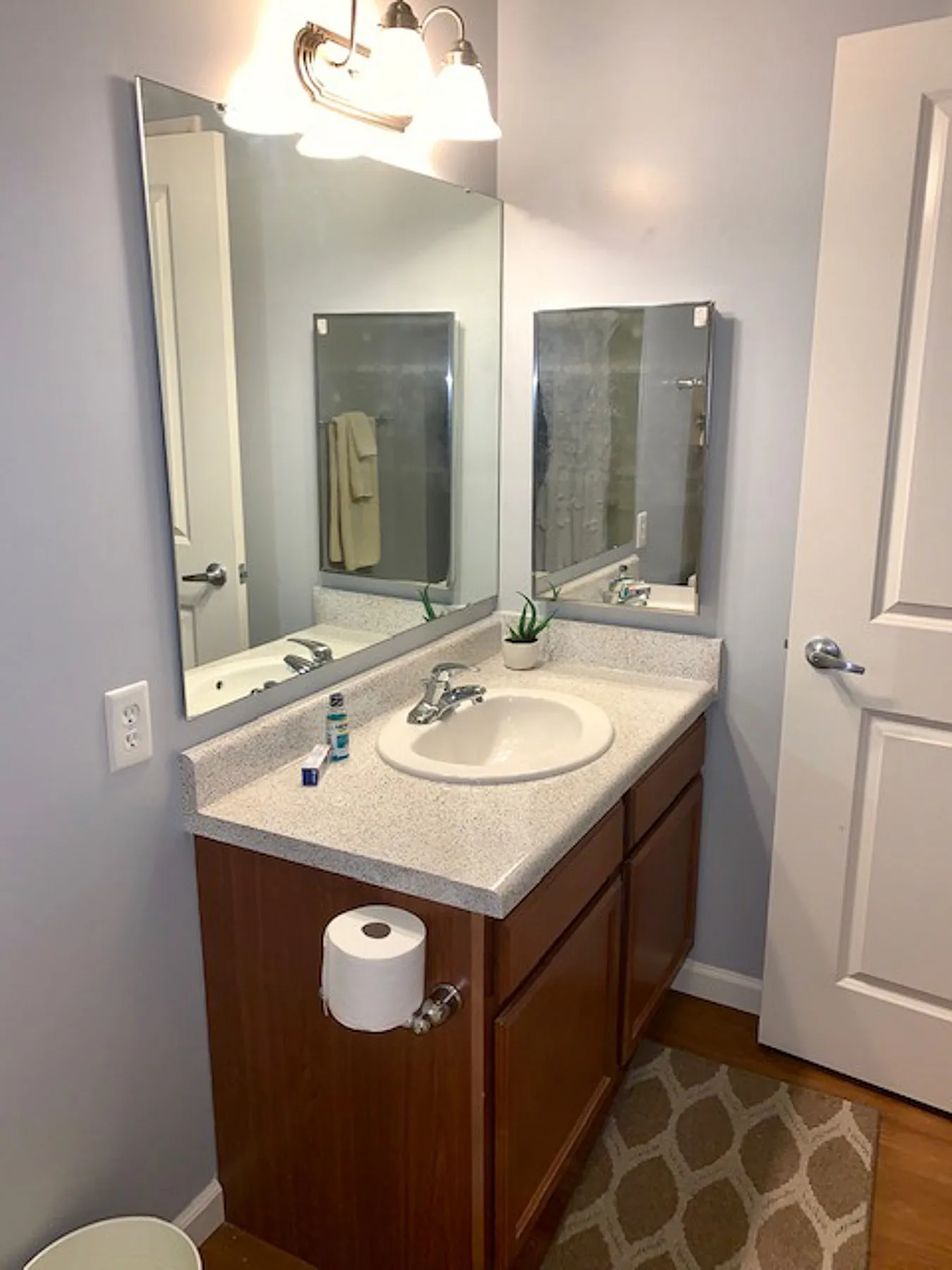 Modern bathroom with a sleek vanity, large mirror, and stylish lighting, offering a clean and inviting space.