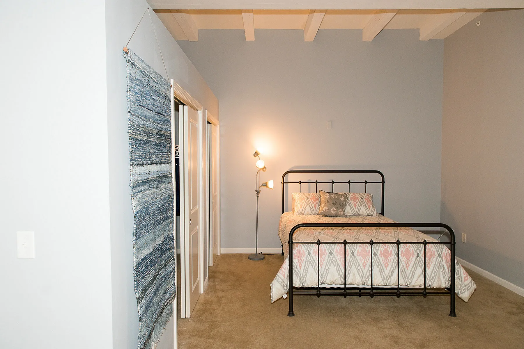 Cozy bedroom with a stylish metal bed frame, soft lighting, and modern decor in a serene setting.