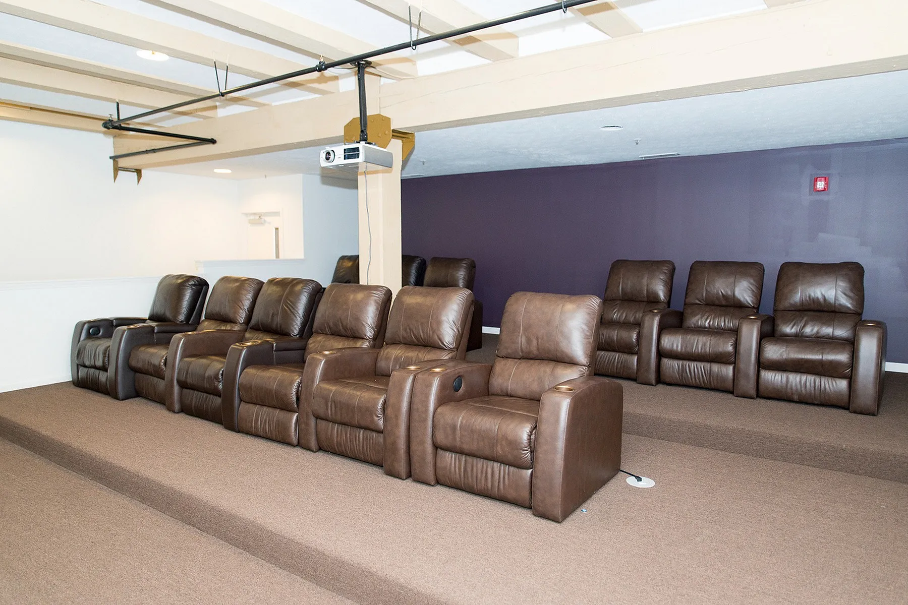 Luxurious home theater featuring plush reclining seats with sleek design, perfect for an ultimate movie experience.