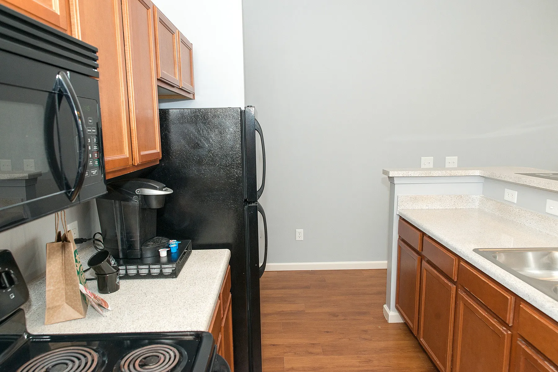 Modern kitchen with sleek countertops, rich wooden cabinetry, and stainless-steel appliances, offering a stylish and functional space for cooking enthusiasts.