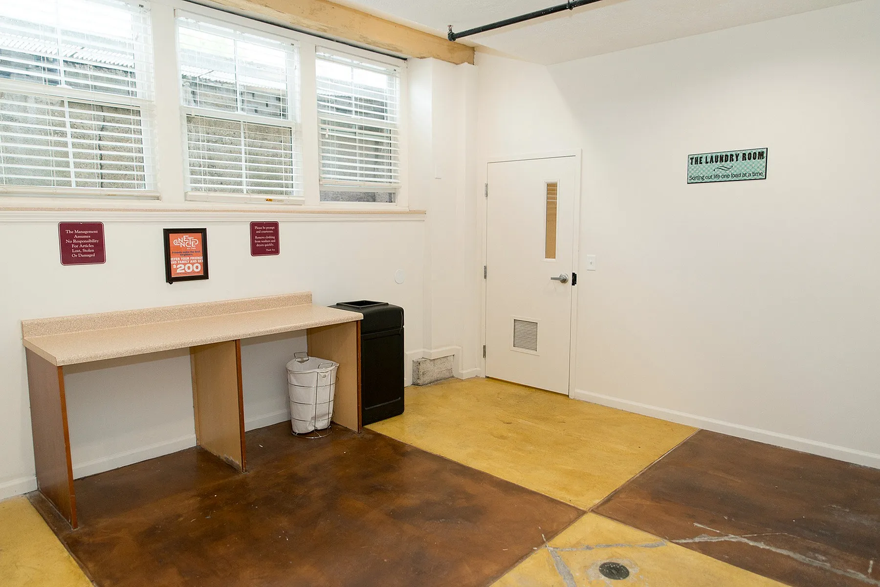 Bright, welcoming laundry room with abundant natural light, featuring spacious countertops and modern design.