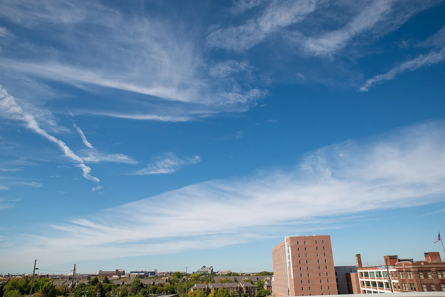 Vibrant urban skyline view with a bright blue sky, perfect for city living enthusiasts.