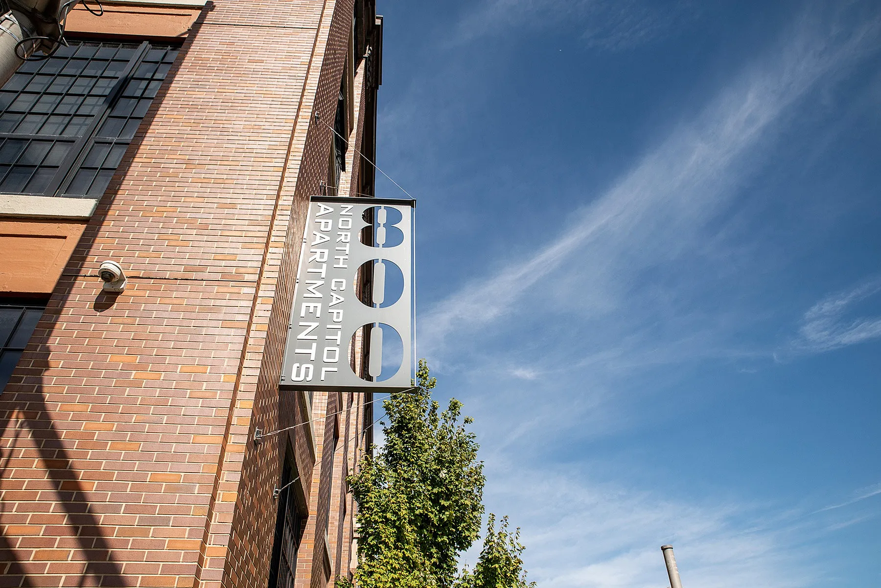 Chic exterior view of North Capitol Apartments showcasing modern architectural style against a clear blue sky.